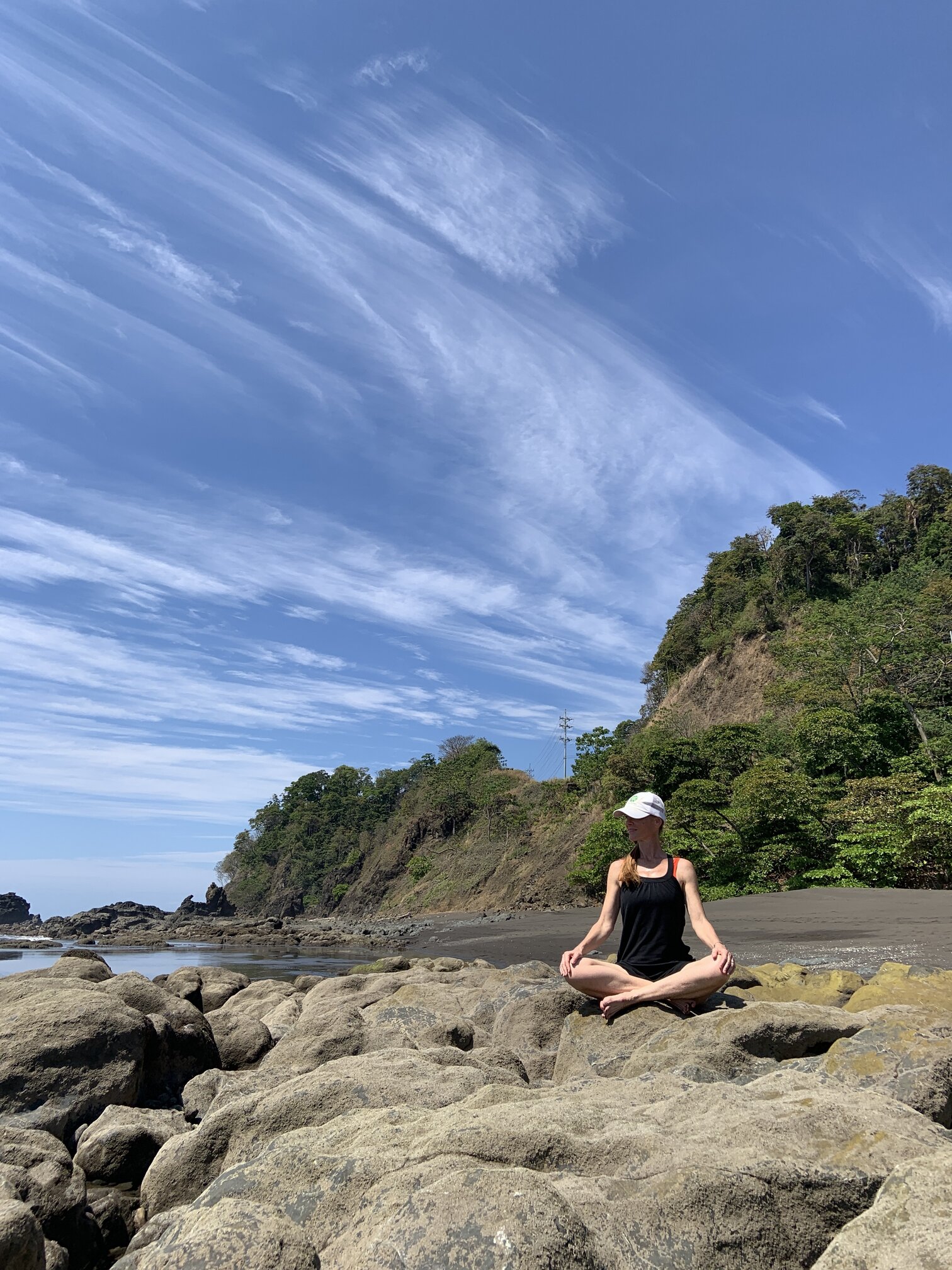 Jennifer sitting on rocks at Playa Hermosa Jennifer sitting on rocks at Playa Hermosa