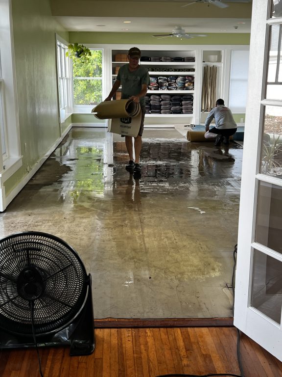 Gary French, Co-owner of The Yoga Sanctuary pulling out the flooring of the downstairs studio space.
